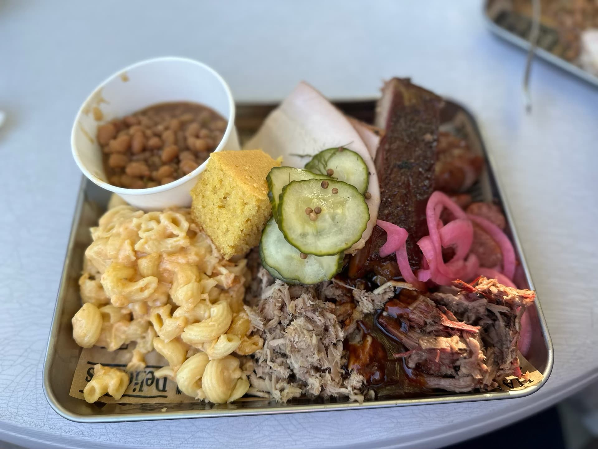 Que17 barbecue plate with pulled pork, brisket, mac and cheese, and all the fixings